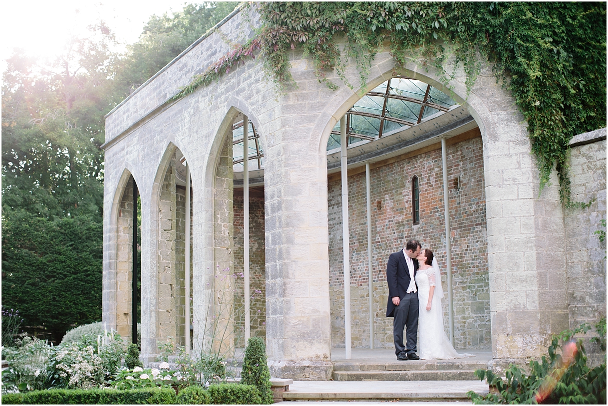 Bride and groom in orangery at Chiddingstone Castle
