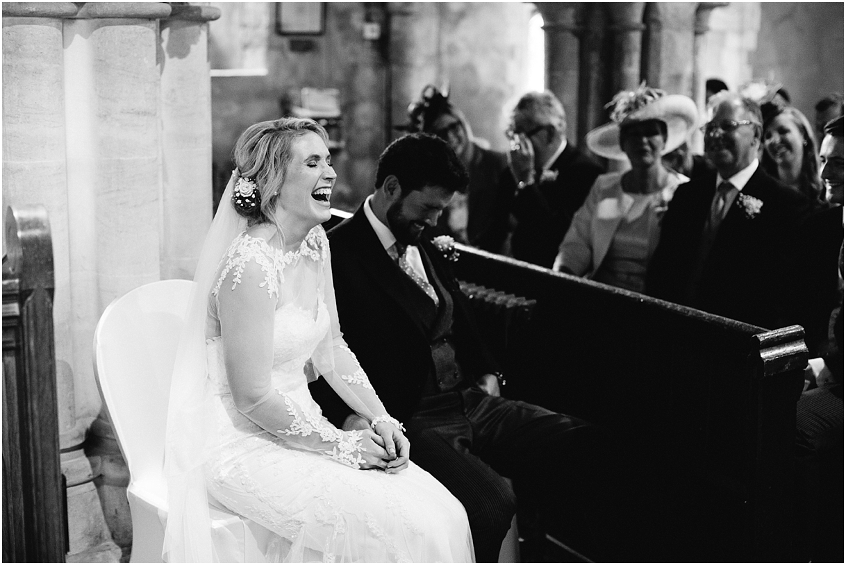 bride-laughing-during-church-service