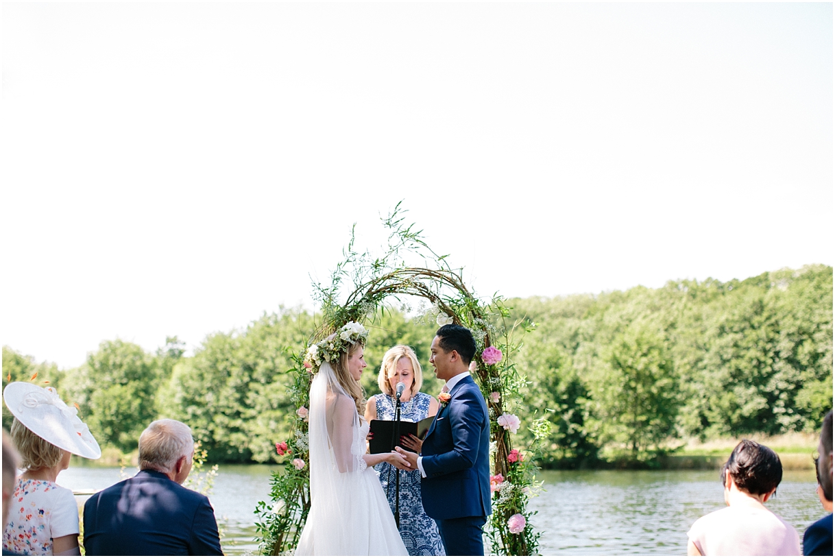 Bride and groom at outdoor wedding ceremony at Duncton Mill Fishery