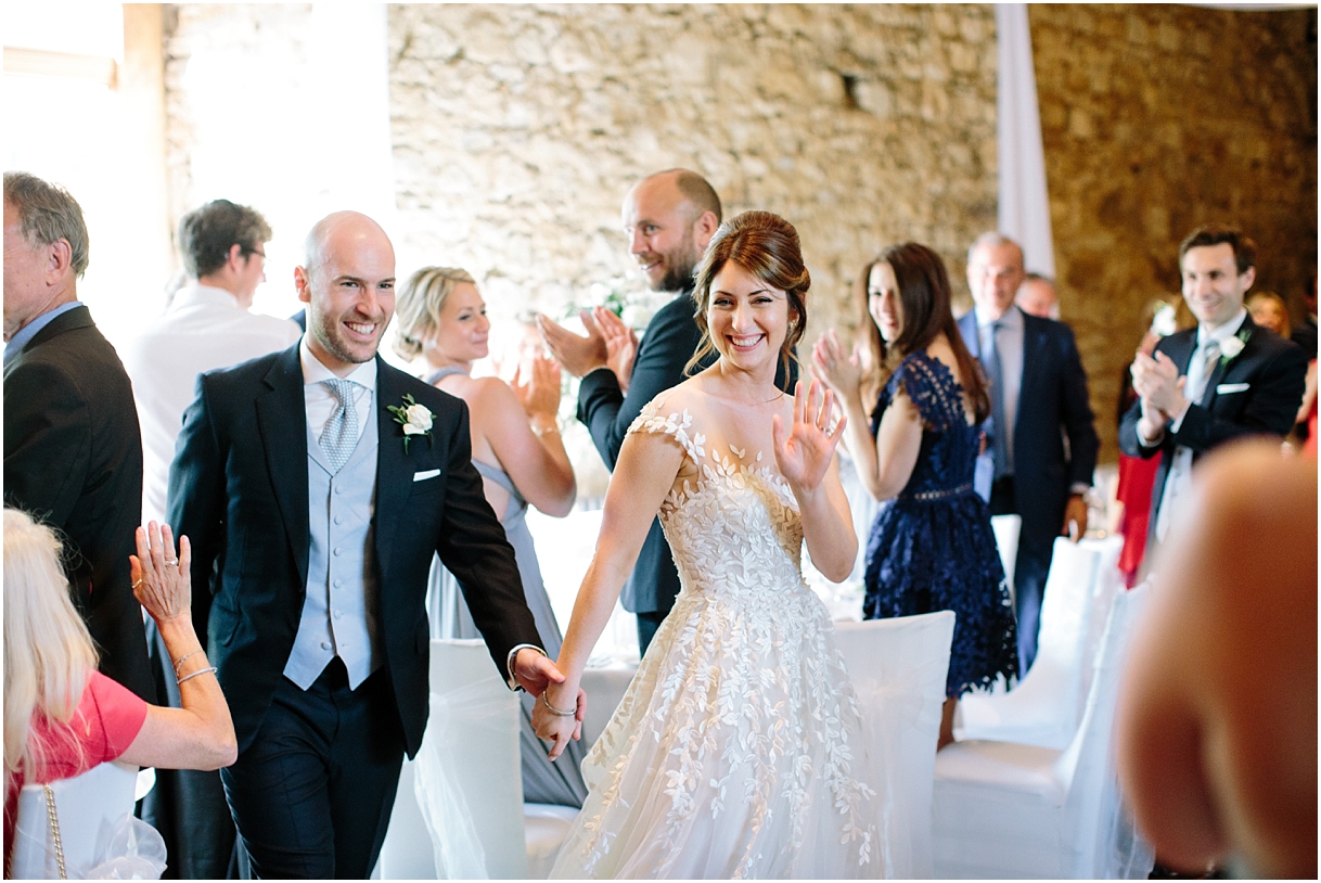 Bride and groom waving