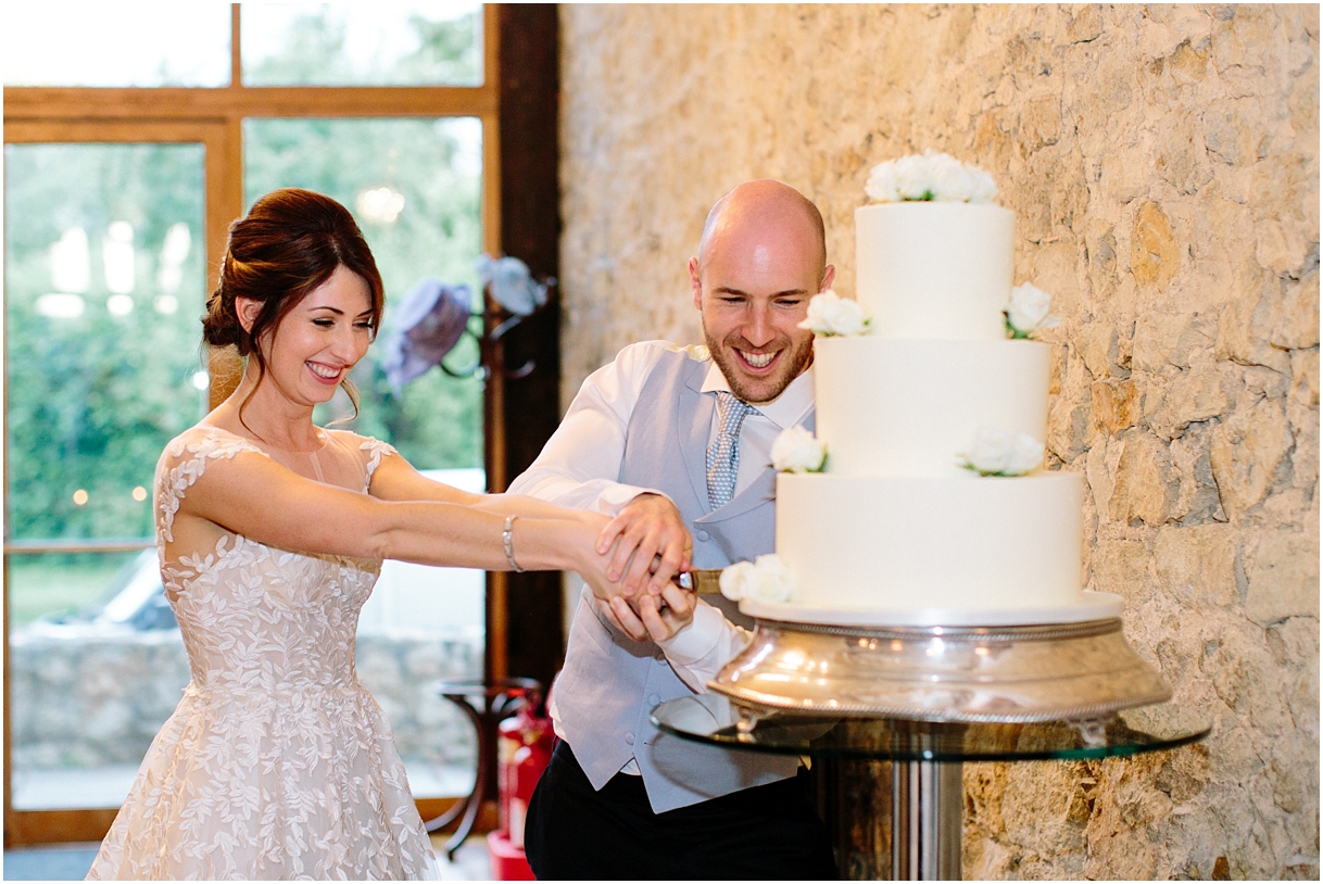 bride and groom cutting cake at Notley Abbey