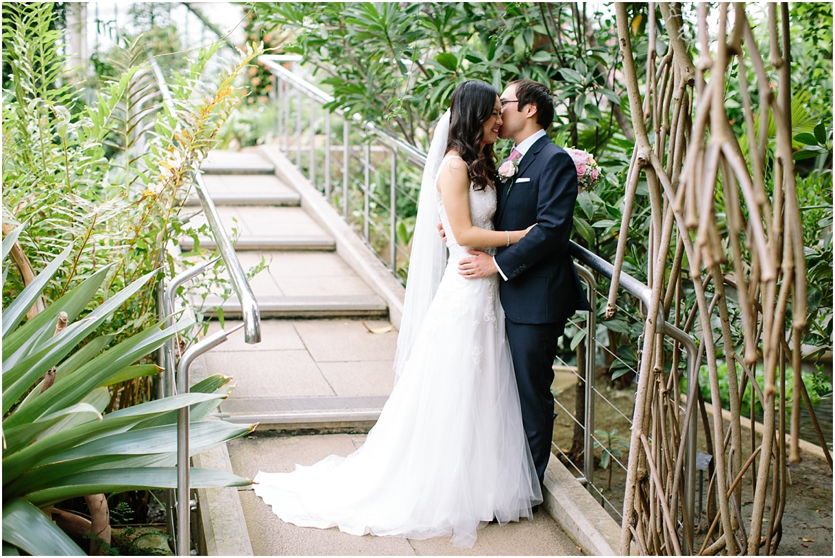 Bride and groom in greenhouse at Kew Gardens