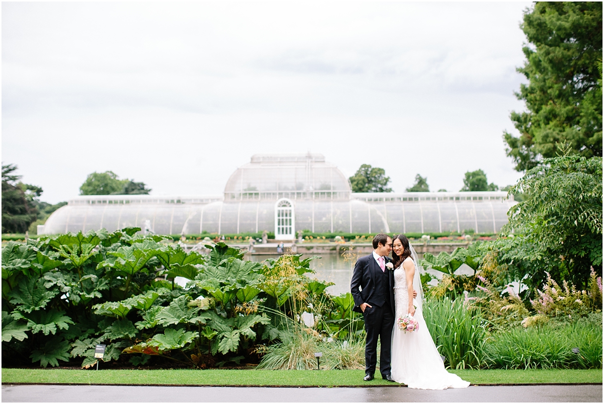 Bride and groom outside greenhouse at Kew Gardens