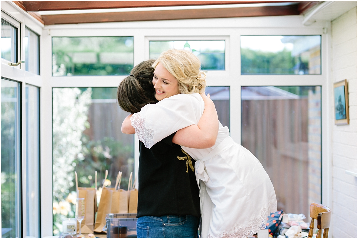 Bride hugging make up artist