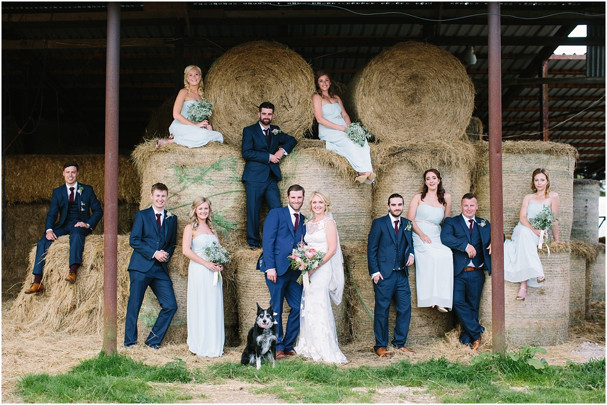 Bridal party on haybales at Warborne Organic Farm wedding