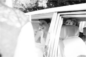 Bride getting into wedding car