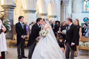 Bride and groom meeting at end of aisle