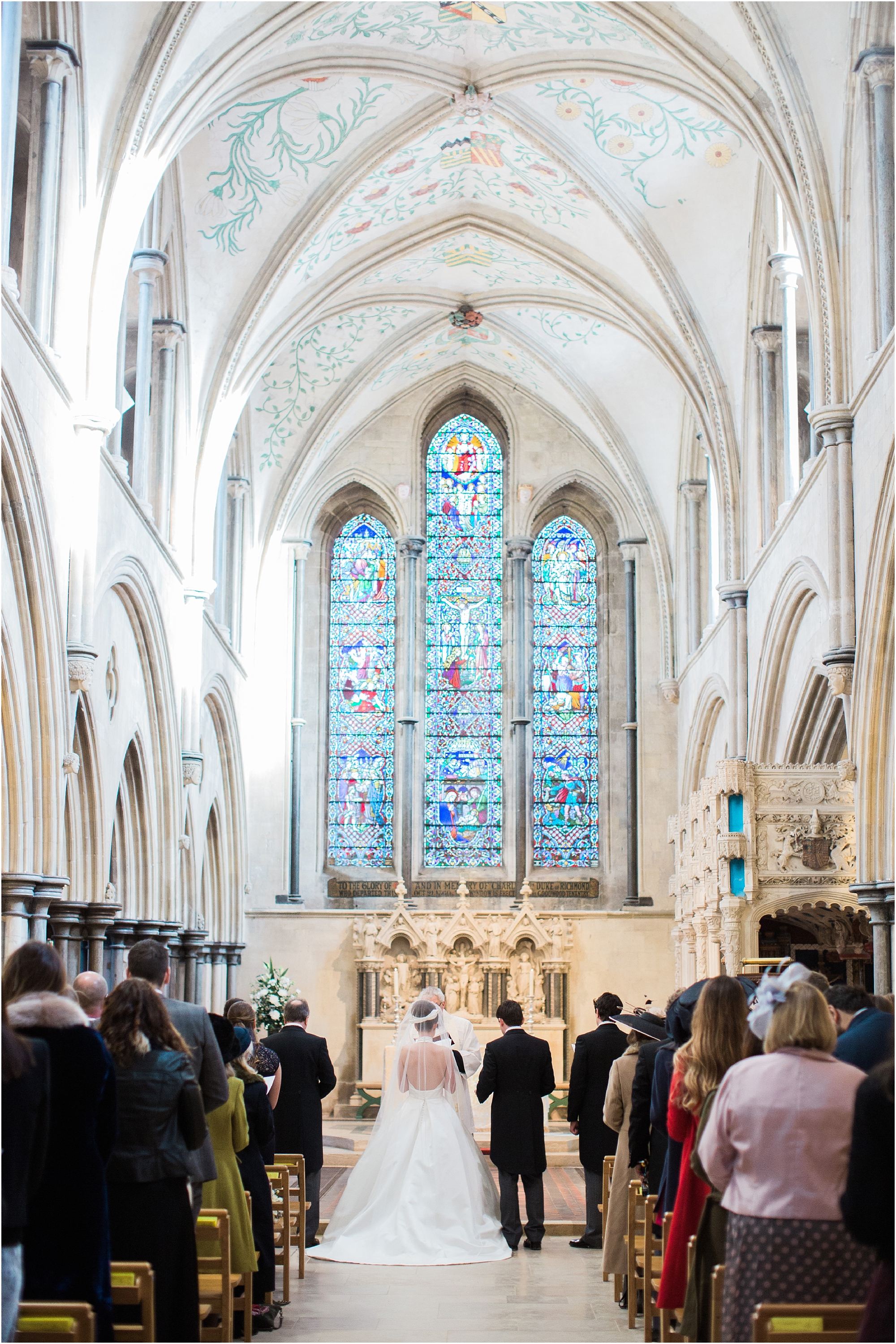 Bride and groom during wedding ceremony at altar of Boxgrove Priory