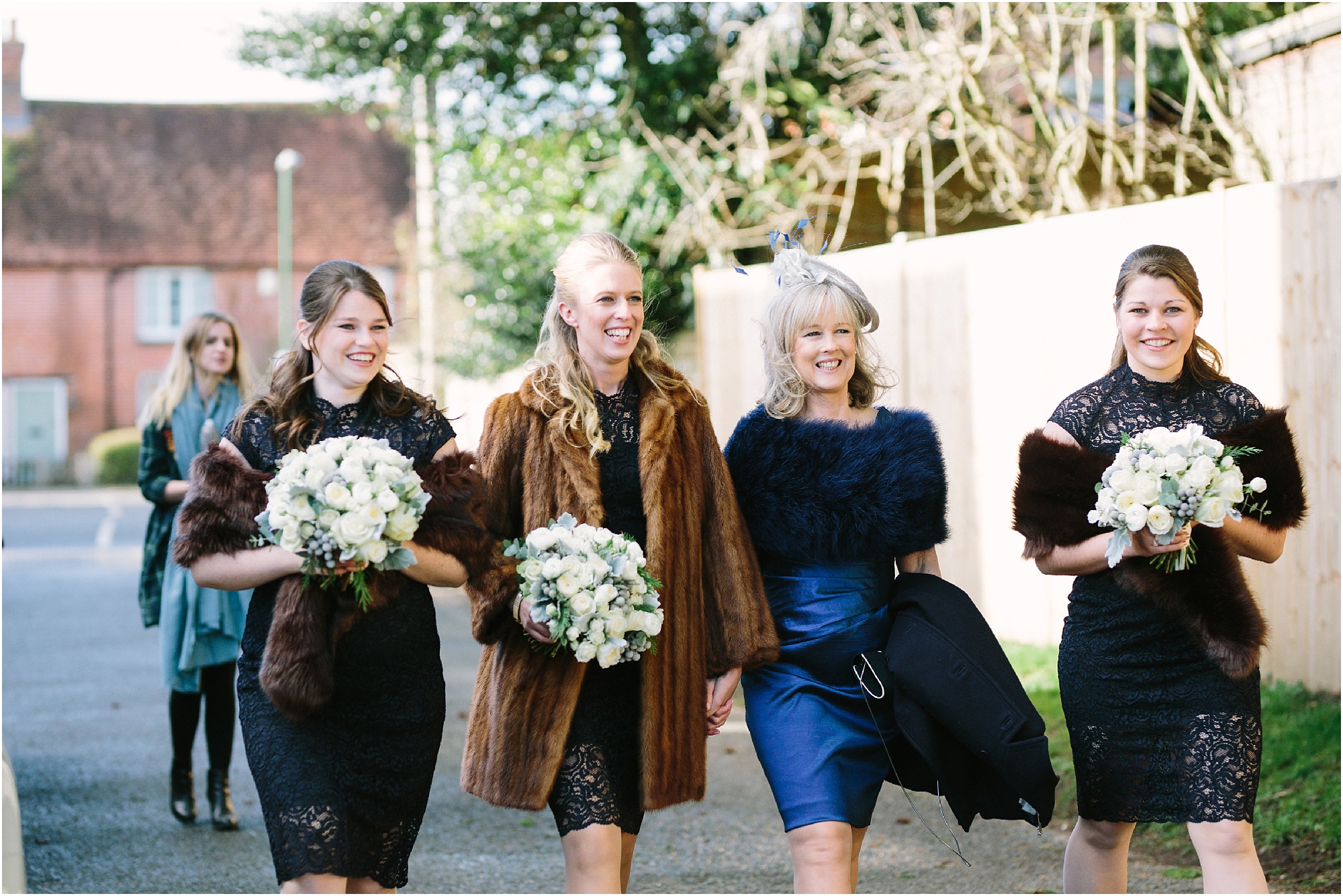 Bridesmaids in navy dresses with fur