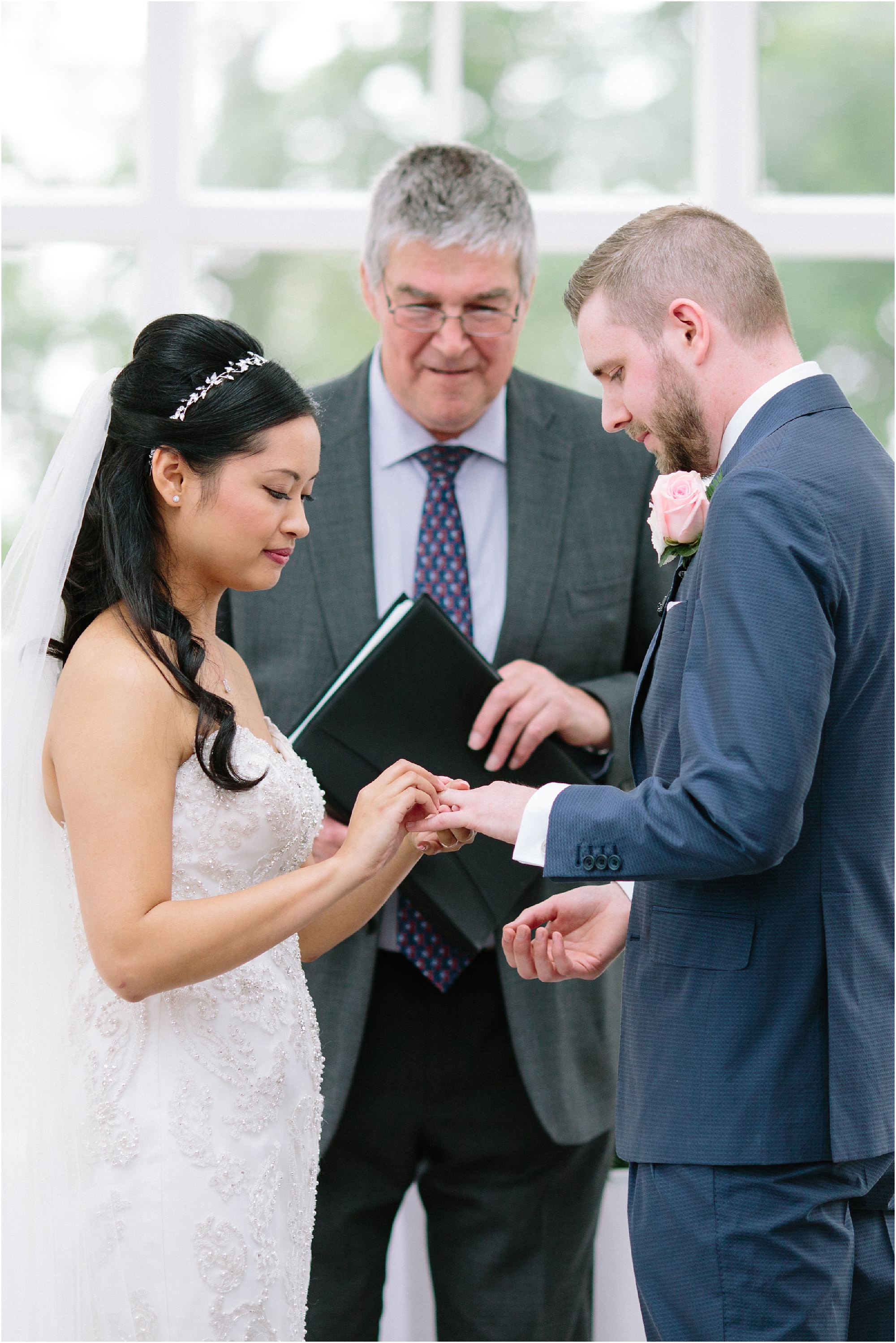 Couple exchanging rings during wedding ceremony