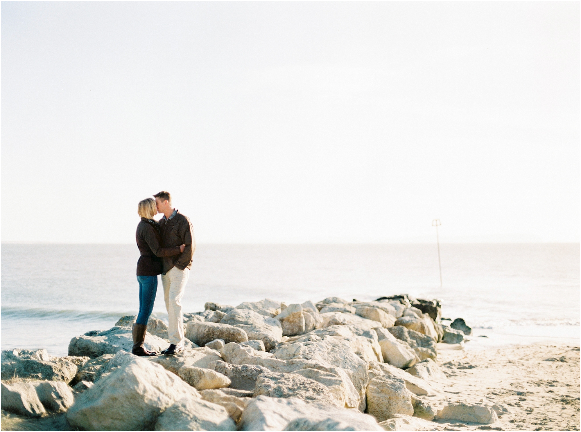Couple kissing on rocks at Hengistbury Head