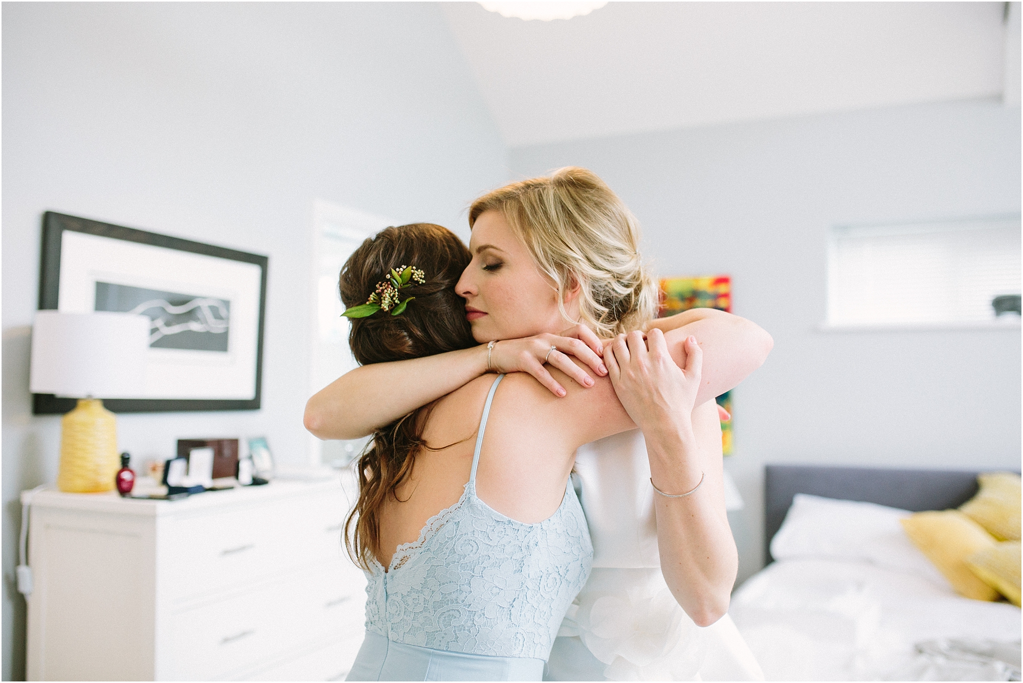 Bride hugging bridesmaid