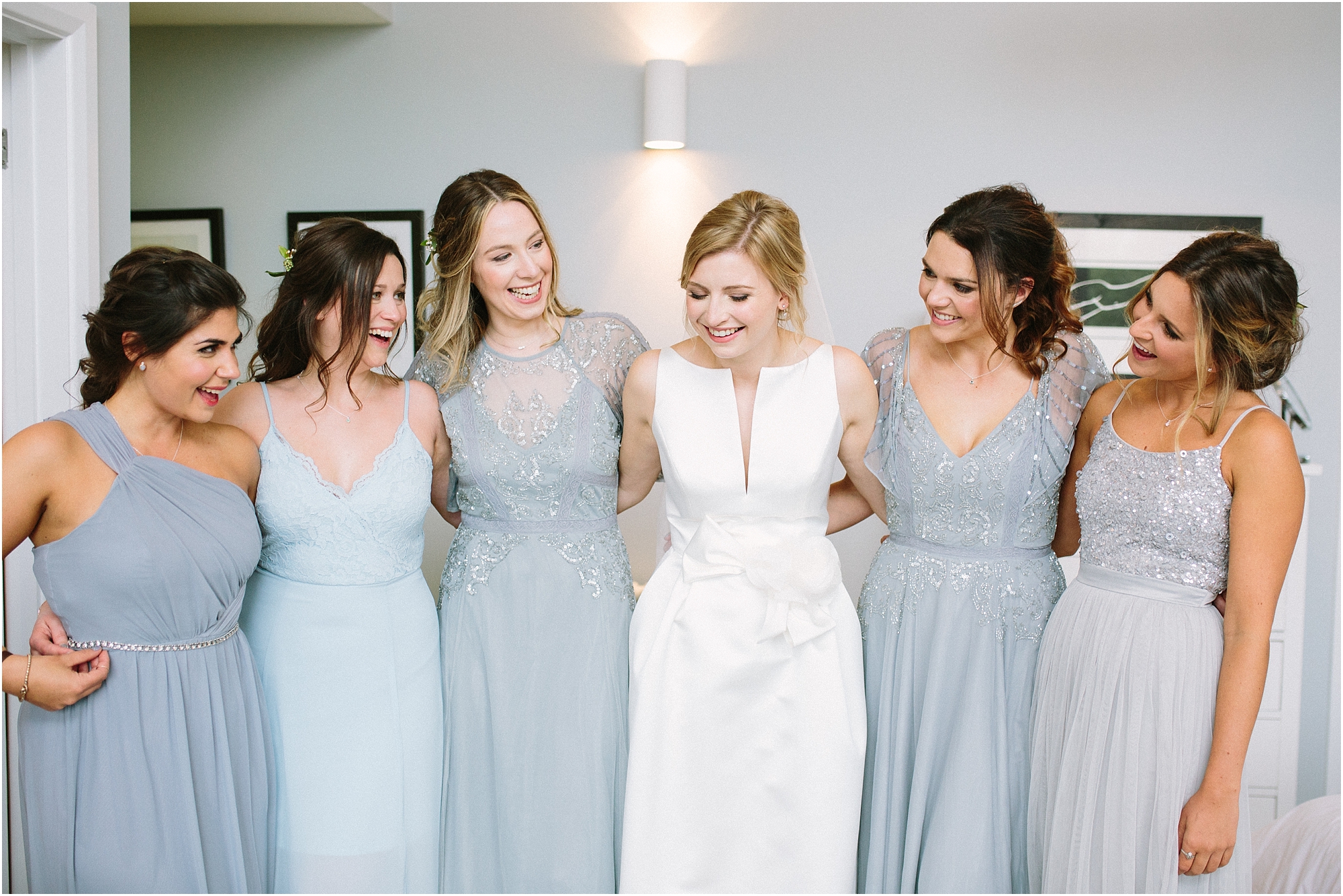 bride with bridesmaids in shades of blue