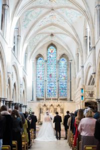 Bride and groom standing at the alter at Boxgrove Priory winter wedding
