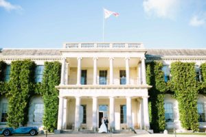 Bride and groom standing in the entrance of Goodwood House