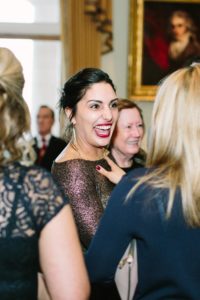 Wedding guests laughing during reception at Goodwood House wedding
