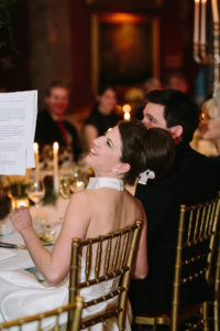 Bride laughing during speeches at Goodwood House wedding