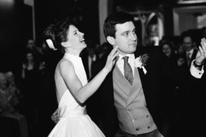 Bride and groom laughing on the dance floor at Goodwood House
