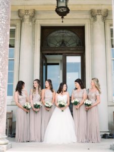 Film wedding photography. Bride with bridesmaids outside Stansted House