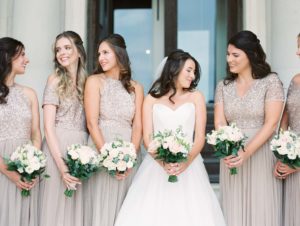 Bride and bridesmaids in blush sequins holding bouquets