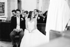 Bride and groom smiling and laughing during church wedding service
