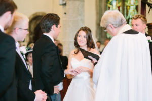 Bride and groom exchanging rings during wedding service at Westbourne Church