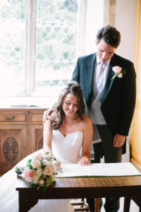 Bride and groom signing the register in church