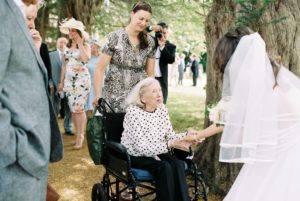 Bride greeting grandmother at wedding