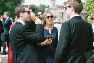 Wedding guests chatting outside Stansted House