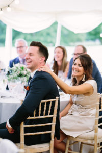 Wedding guests enjoying speeches on wedding day at Stansted House