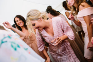 wedding guests in pin spotty dress dancing at Stansted House wedding