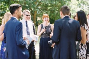 Wedding guests laughing at Chiddingstone Castle