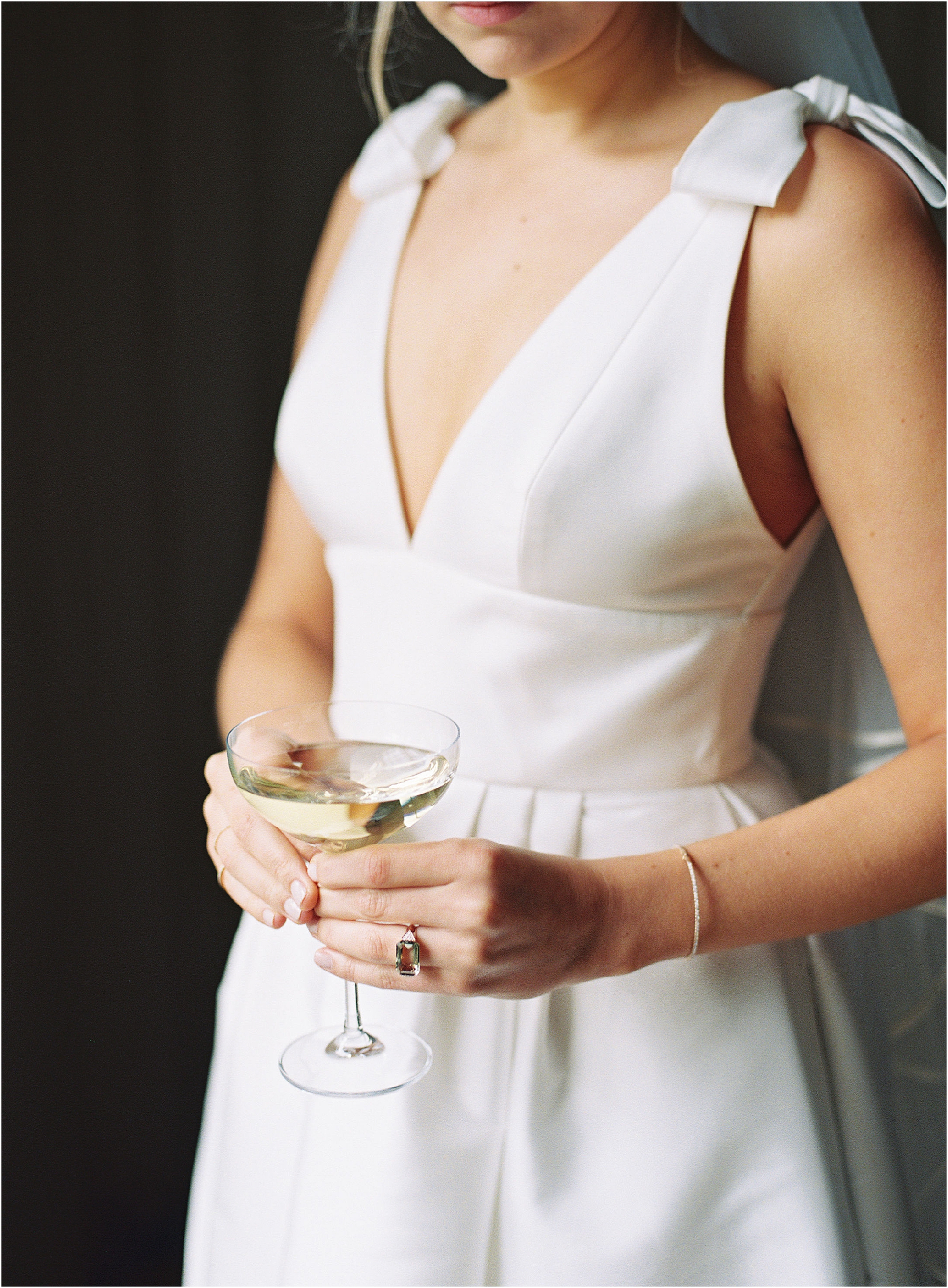 Elegant and sophisticated bride holding glass of champagne