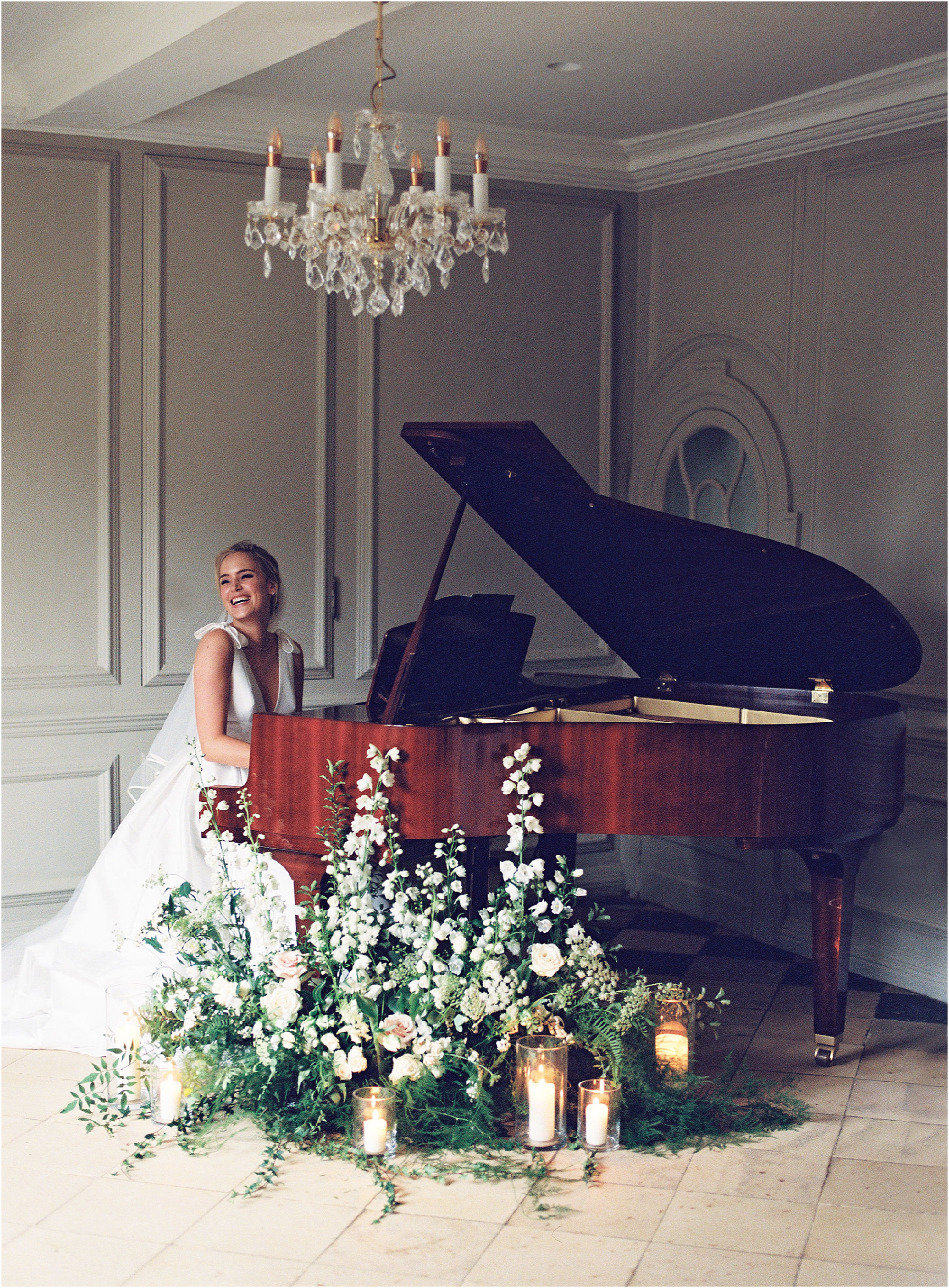 Elegant bride sitting at the grand piano at Thorpe Manor, Oxfordshire