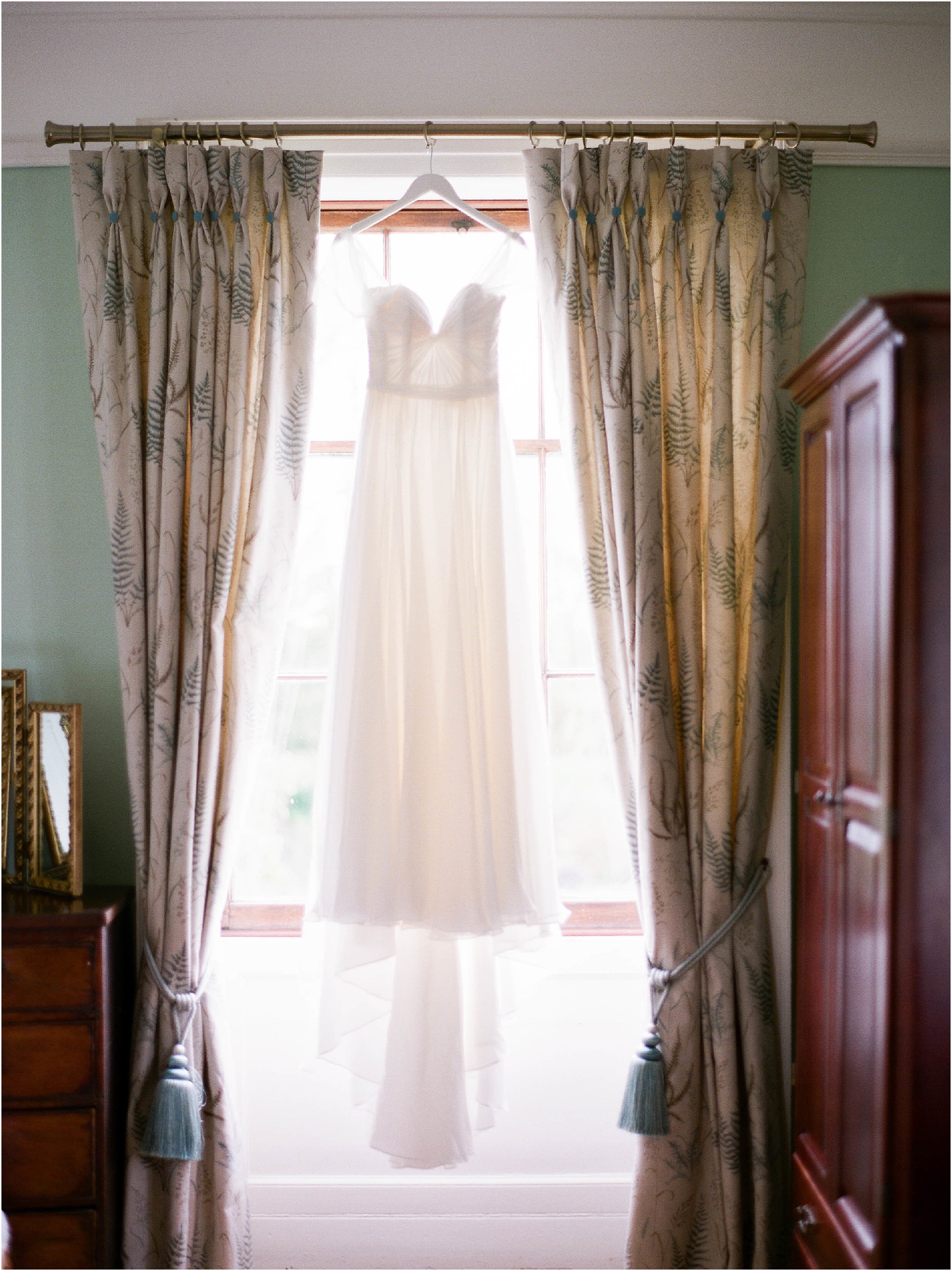 Naomi Neoh wedding dress hanging in window