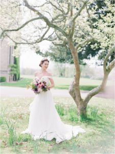 Bride standing under magnolia tree at Hill Place