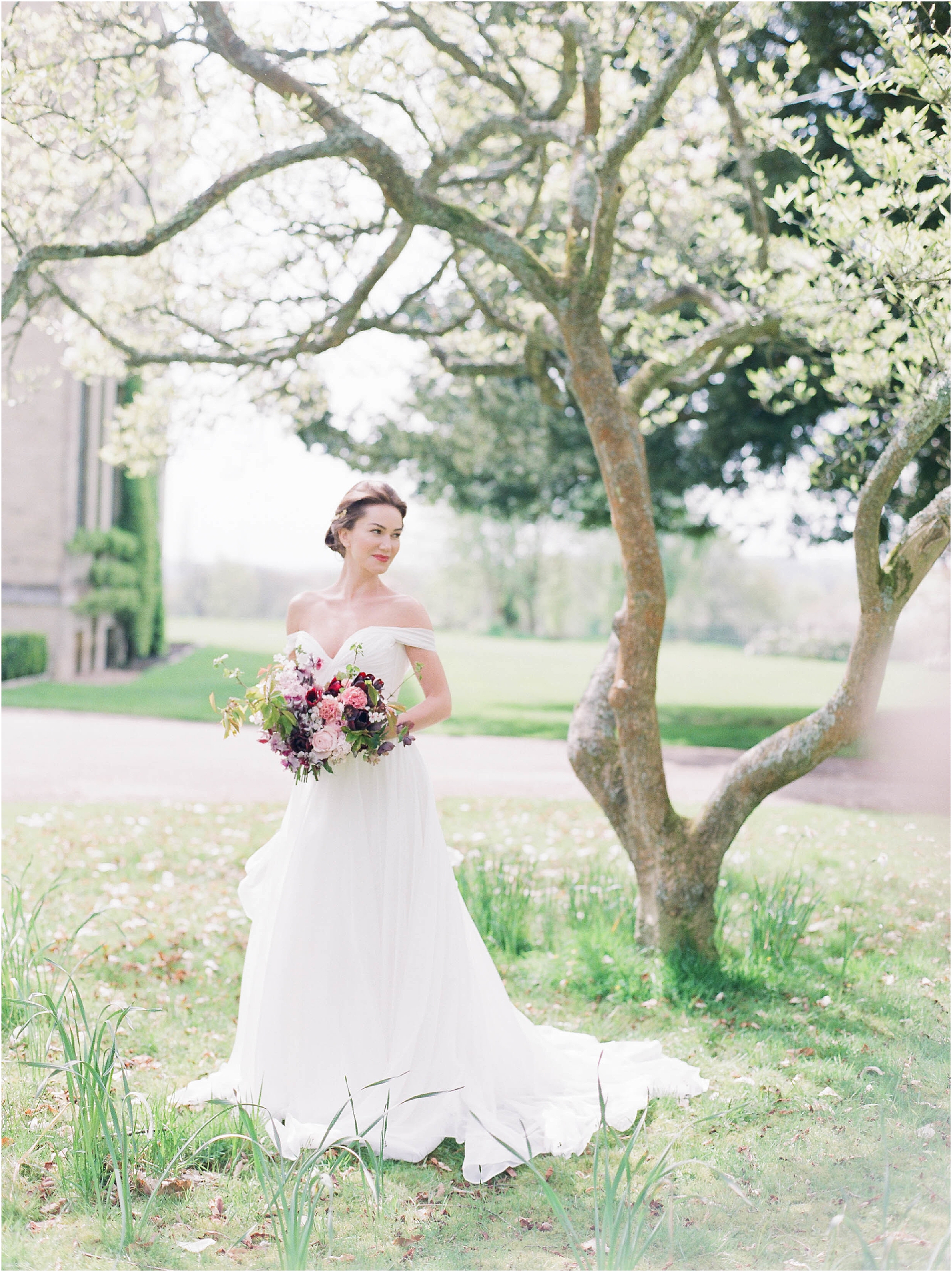 Bride standing under magnolia tree at Hill Place