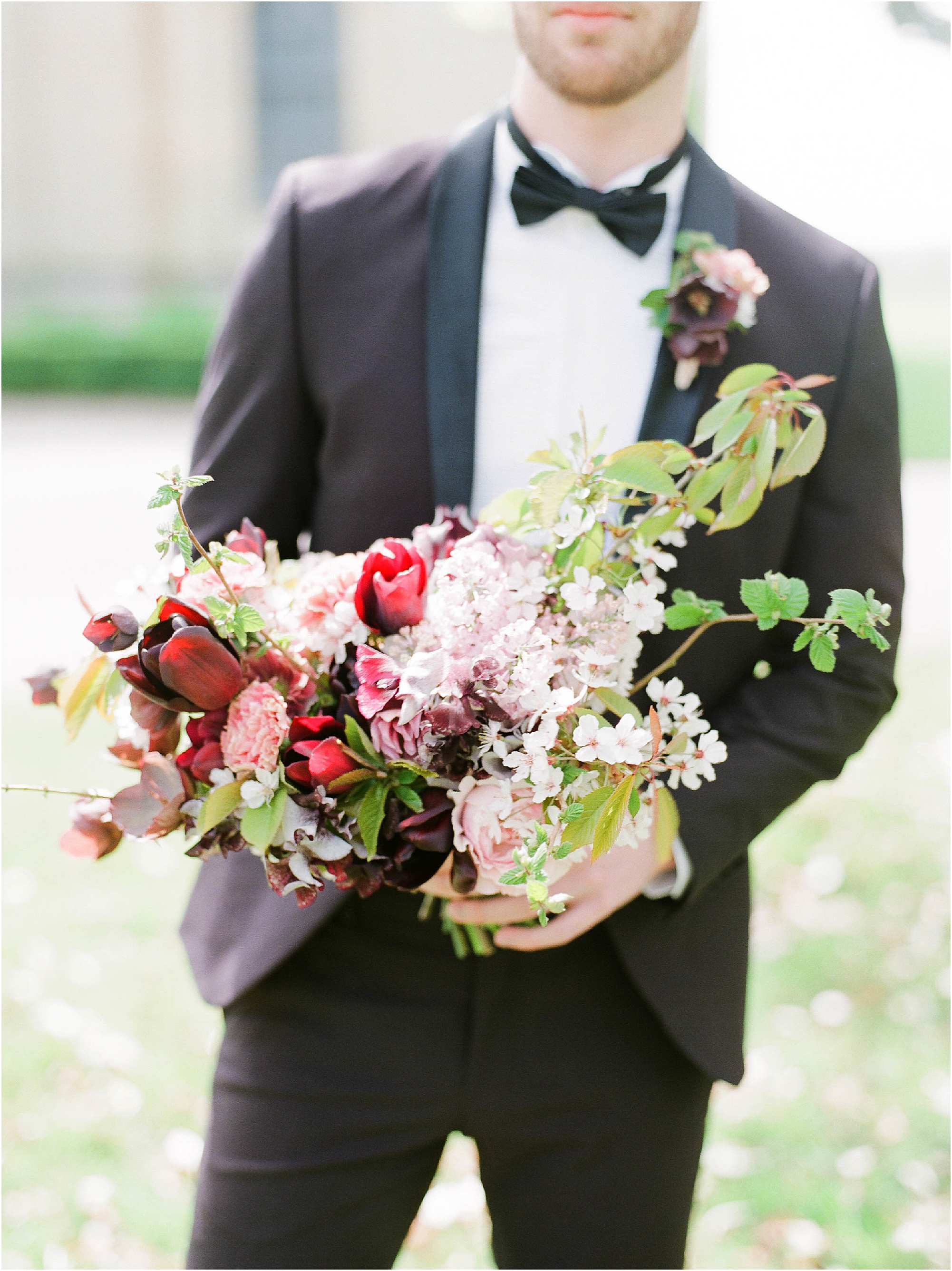 Groom holding bouquet by Martha and the meadow
