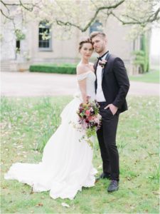 Bride and groom standing outside Hill Place Wedding Venue Hampshire