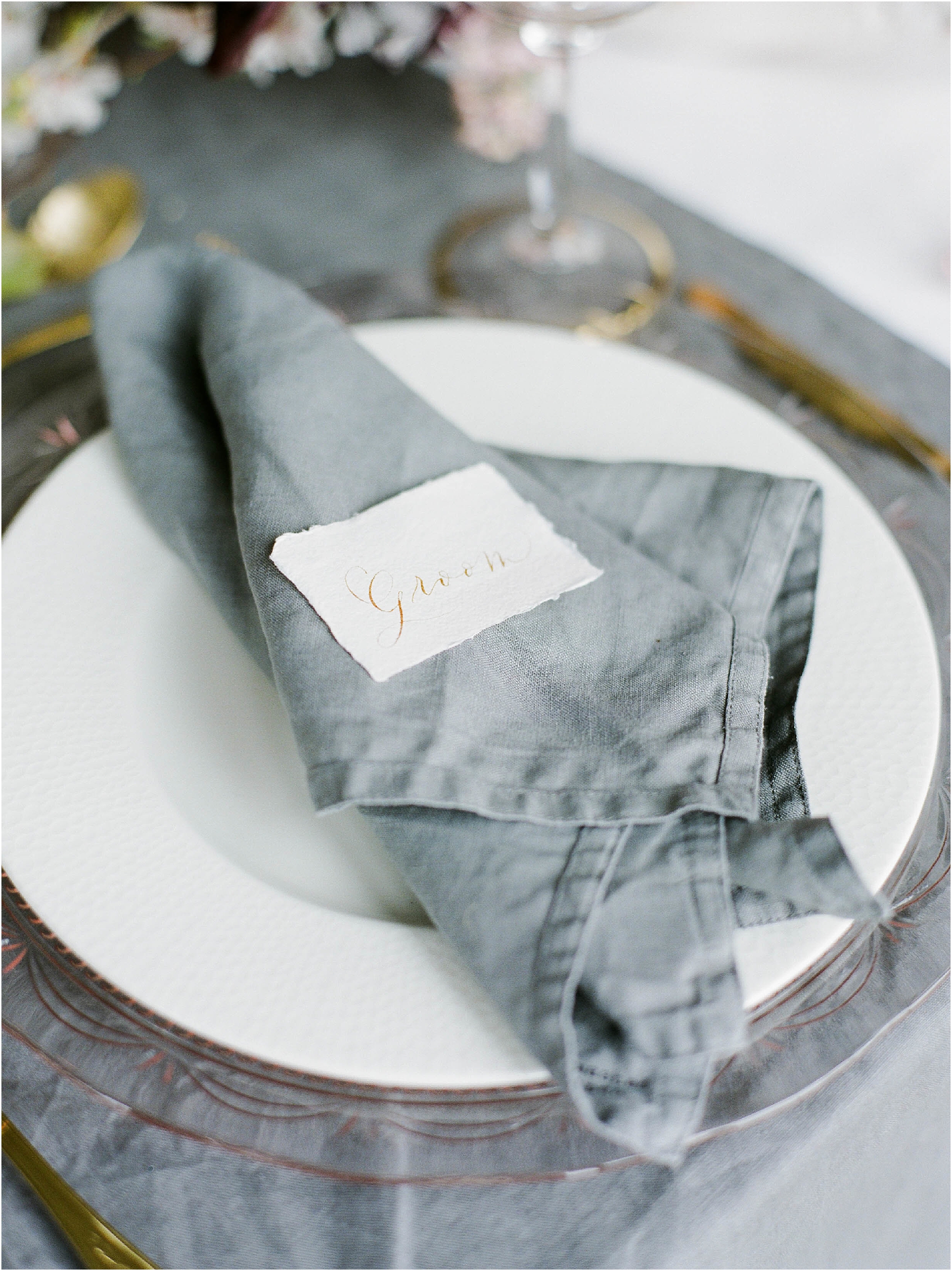Groom table place name on grey linen napkin