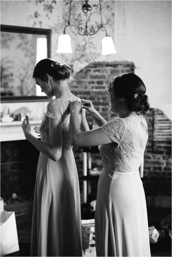 bridesmaids doing their dresses up