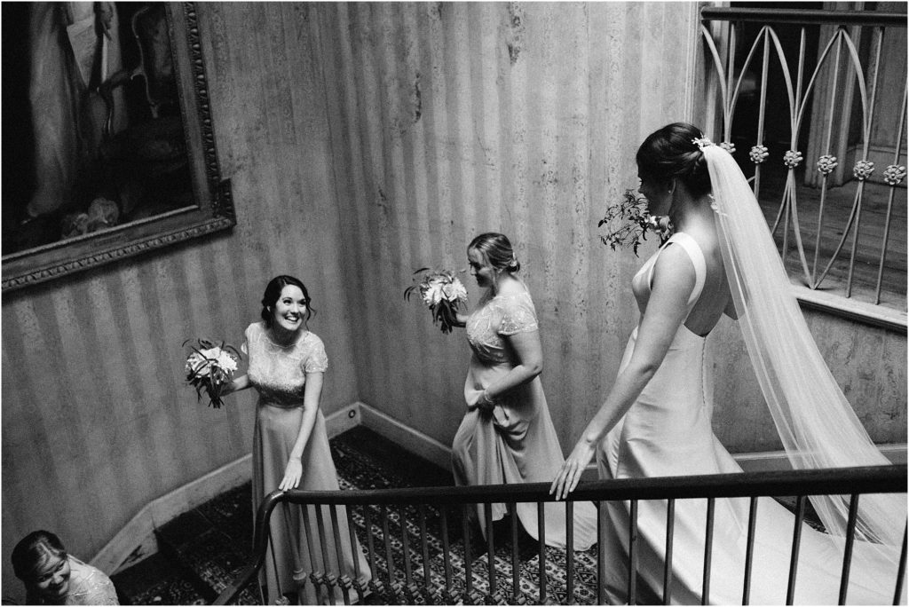 bridal party descending the stairs at St Giles House 
