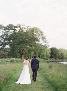 Bride and groom walking away at St Giles House wedding