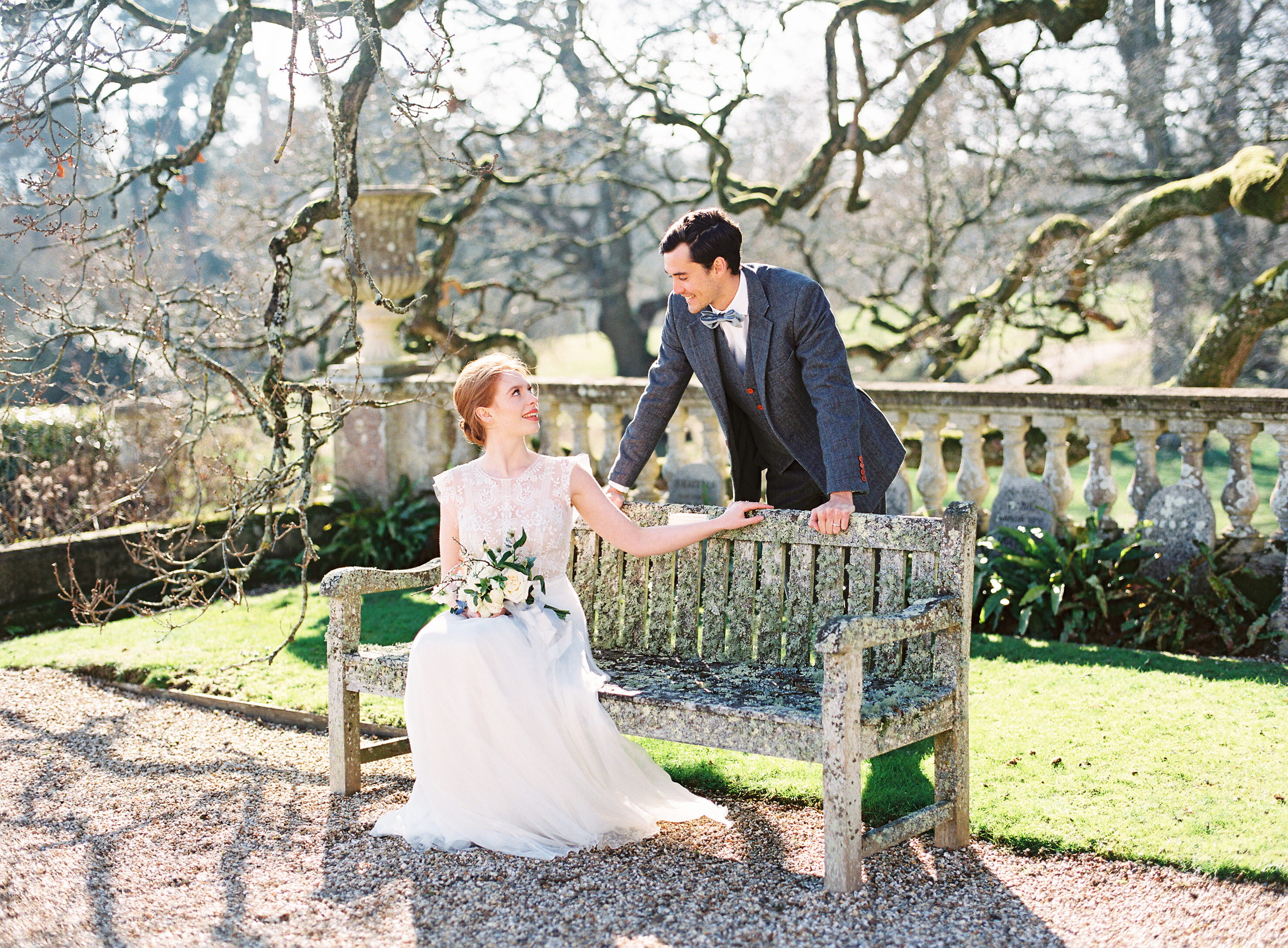 Bride and groom sitting on the bench at Somerley House