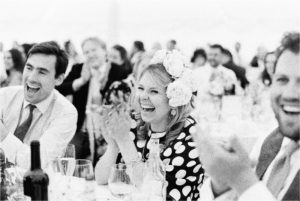 wedding guests laughing and clapping during speeches