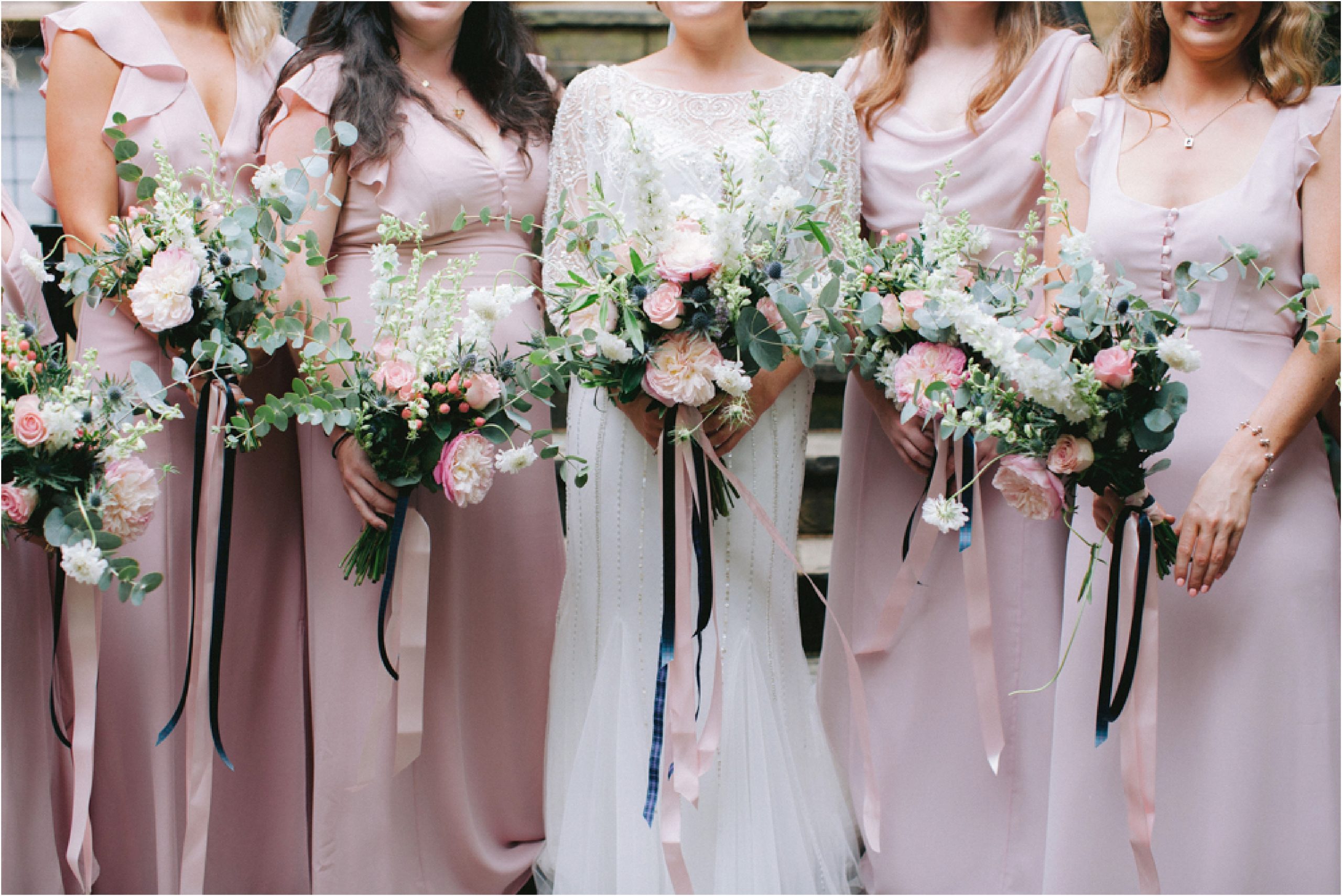 wedding bouquets and bridesmaid in blush pink