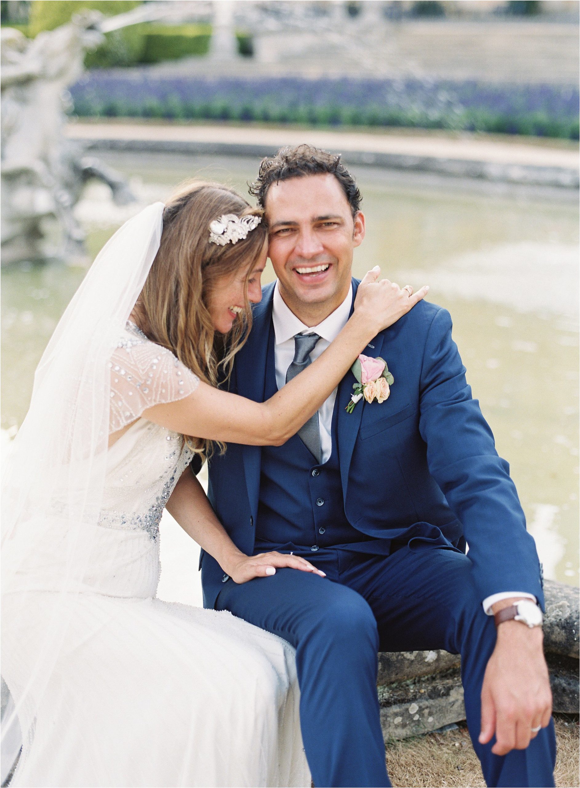 Groom laughing during romantic couple portraits