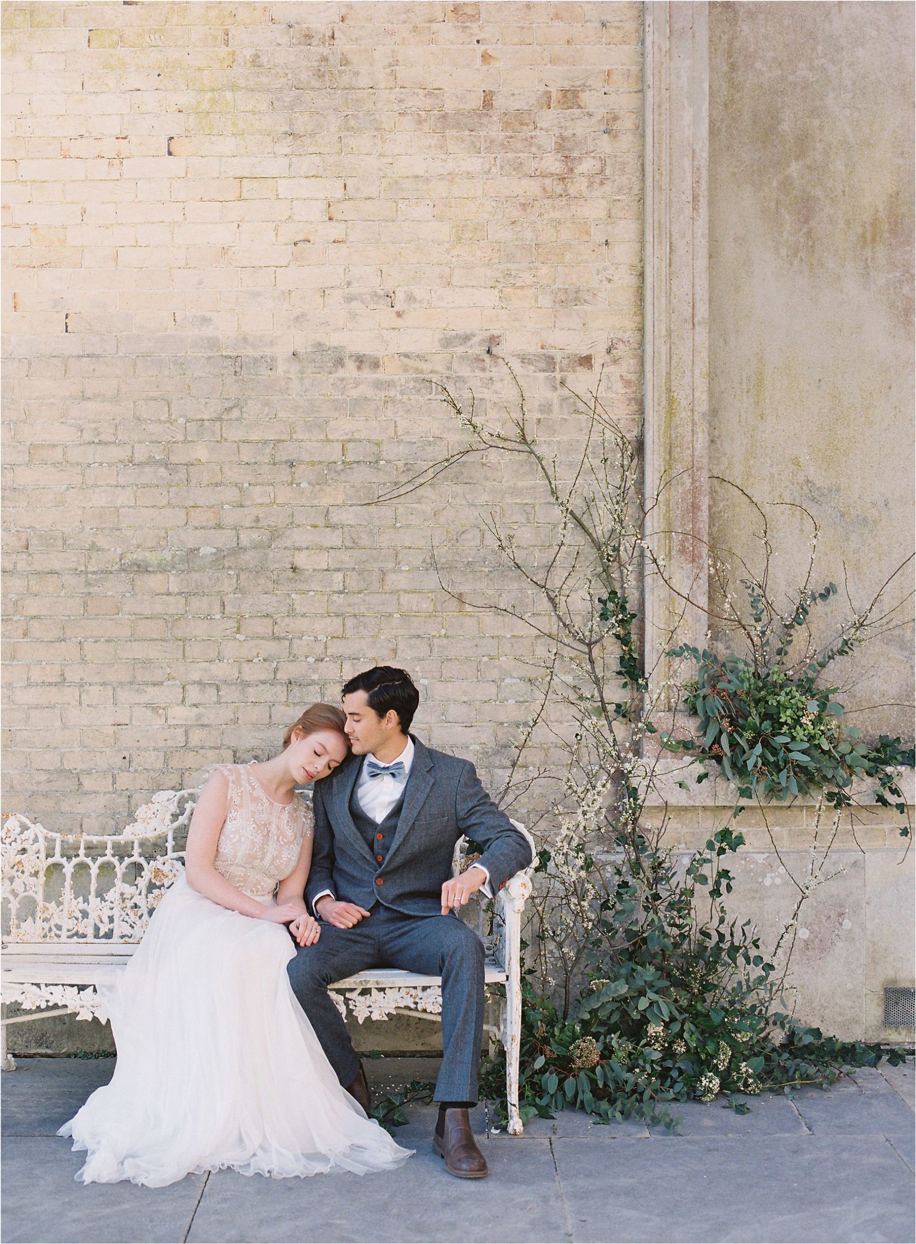 Couple cuddling on bench at Somerley House wedding venue