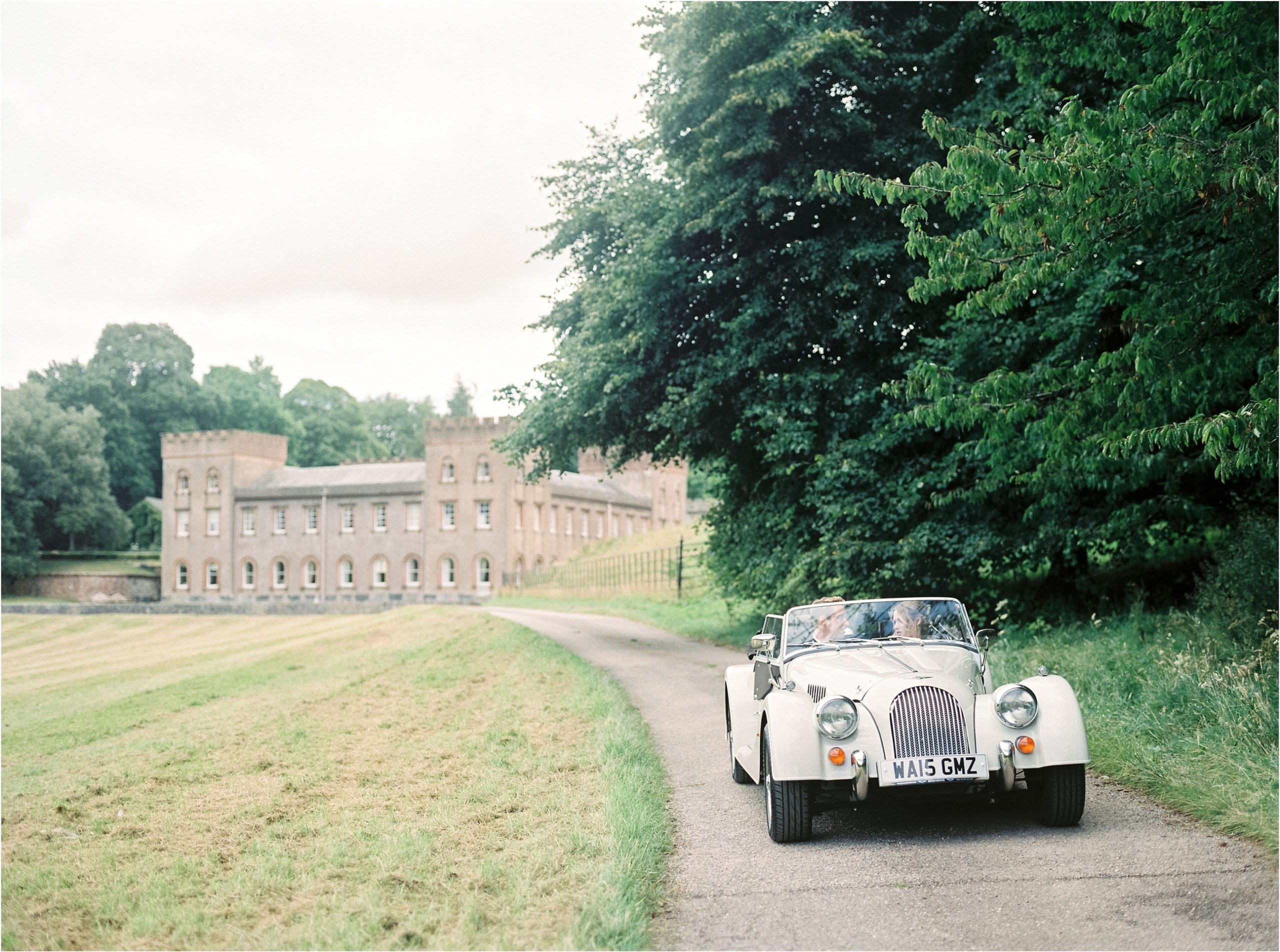 vintage car driving away from Ugbrooke House