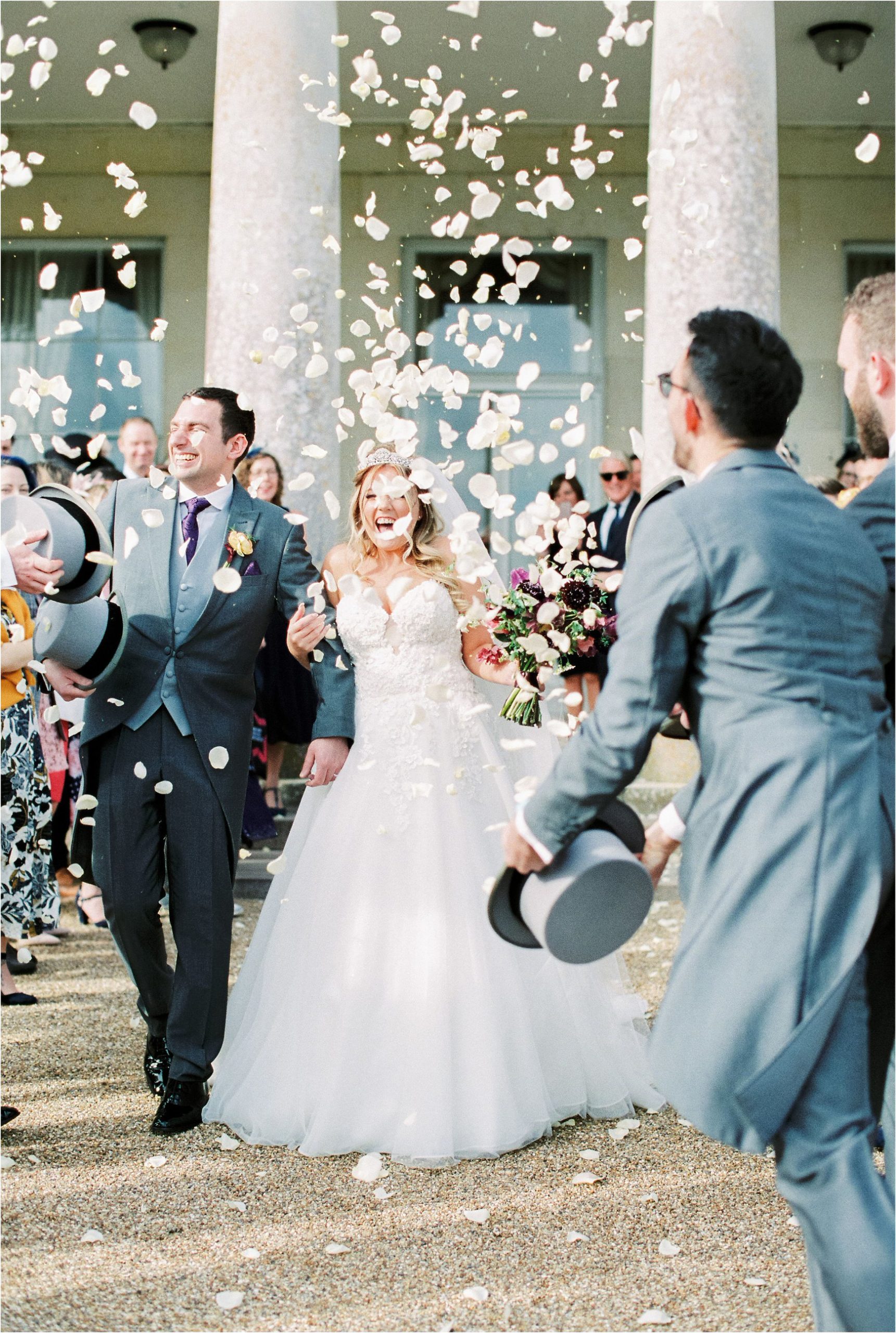 Bride and groom and confetti at Goodwood House